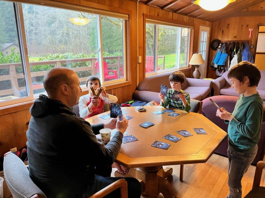 I play Go Fish with my three boys at a table in our lodge at Smith Creek Village.