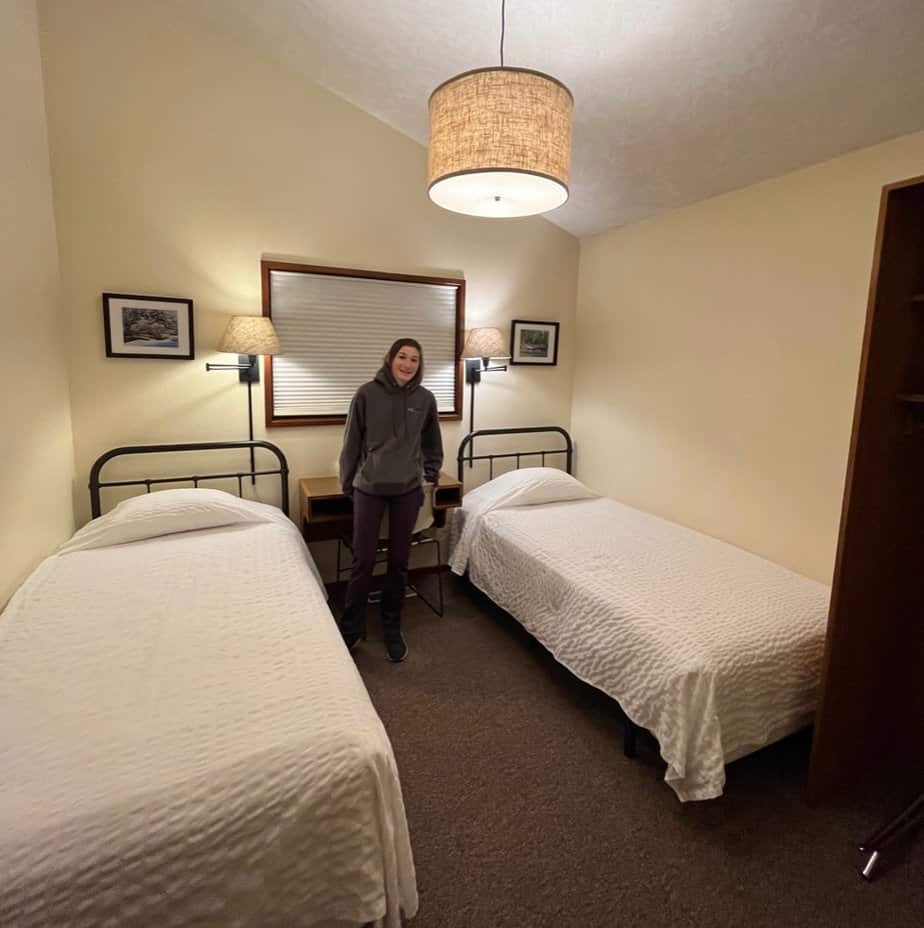 Our daughter stands in on of the comfortable bedrooms that we enjoyed at Smith Creek Village.