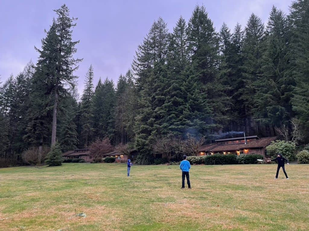 Children play frisbee on the central field at Smith Creek Village. 