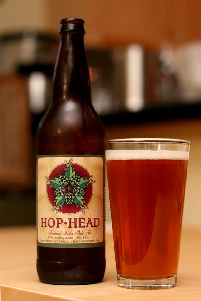 Image shows a full glass of Bend Brewing's Hop Head beer.