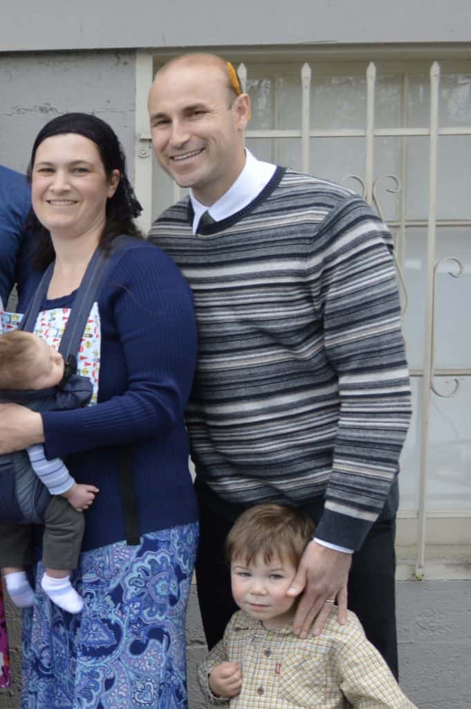 Couple with 2 children in church clothes.