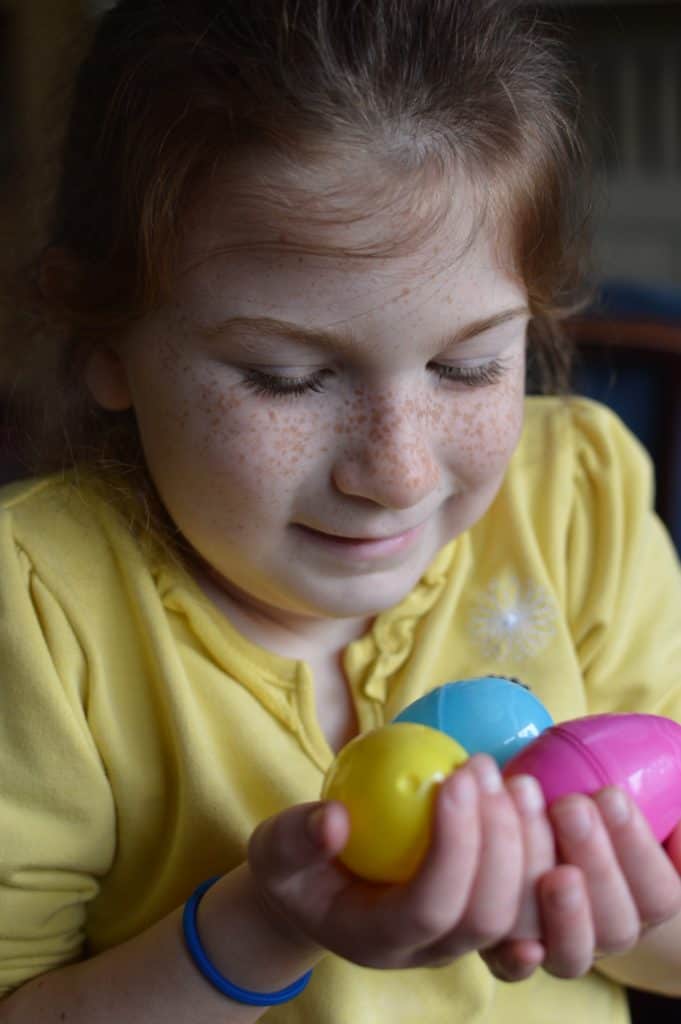 Girl holding plastic Easter eggs. non candy ideas for easter baskets