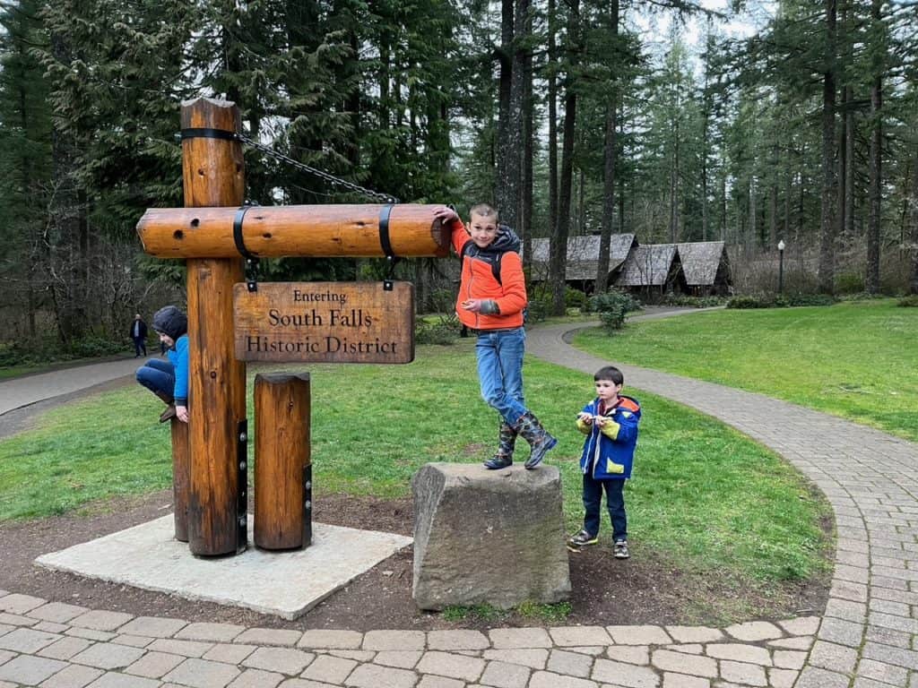 Boys play around a sign at the South Falls Day-use area at Silver Falls State Park.