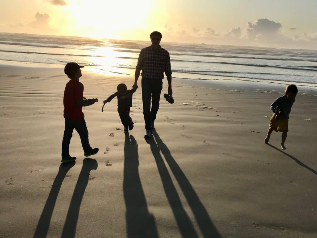 Silhouetted husband with boys at sunset on the beach. My husband has no patience for adult bullies.