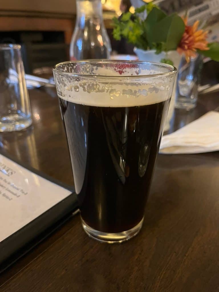 A glass of Mt. Bailey Porter sits at our dining table at Wolf Creek Inn. Mt. Bailey Porter is produced by Two Shy Brewing, one of several breweries in Roseburg Oregon.