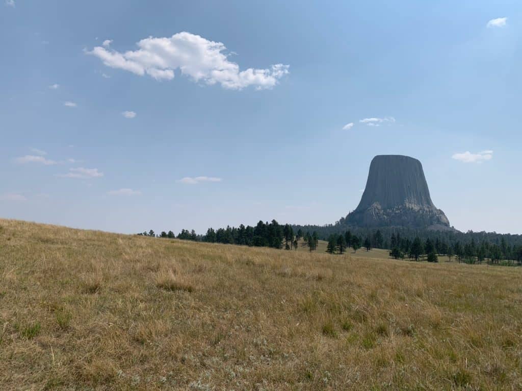 Devil's Tower dominates the horizon at Devil's Tower National Monument. Devil's Tower is one of the best things to see along I-90 in Wyoming.