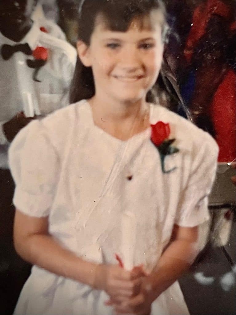 Girl in white dress with red rose. Does TMJ cause migraines?