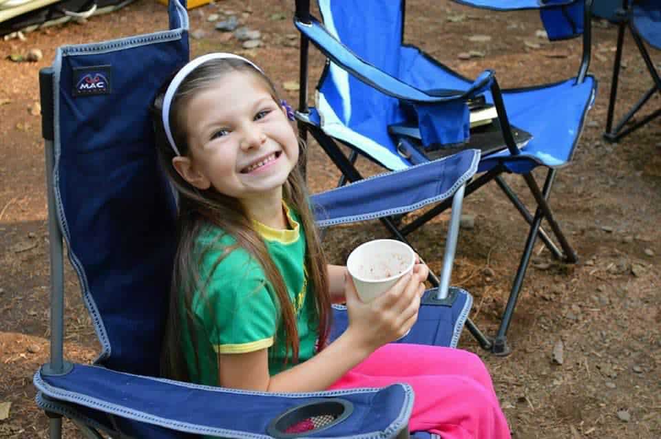 Girl in camp chair.