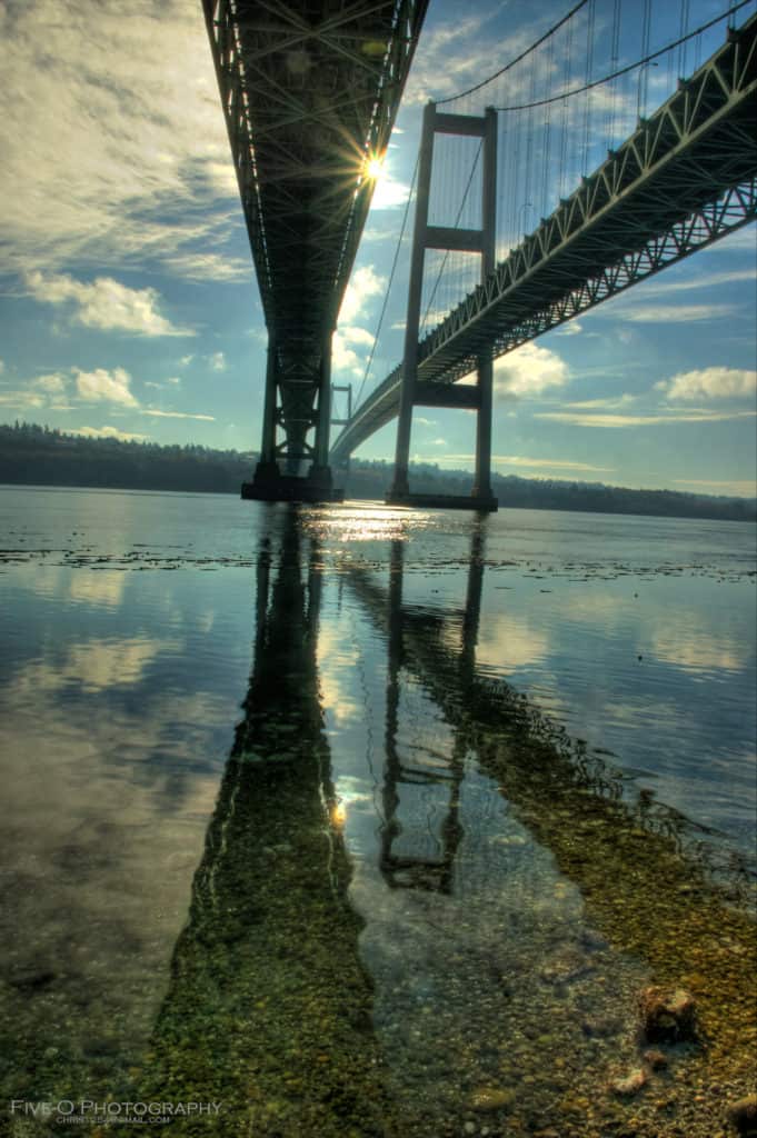 The sneaks through one of the underbeams of the Tacoma Narrows Bridge. The Tacoma Narrows Bridge is one of the highest bridges in the US.