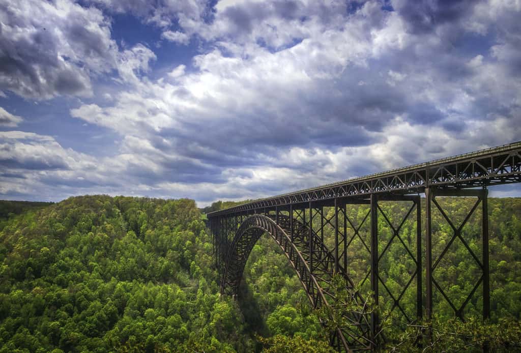 The New River Gorge Bridge stands amid the rolling hills of West Virginia. New River Gorge Bridge is one of the 89 highest bridges in the US.