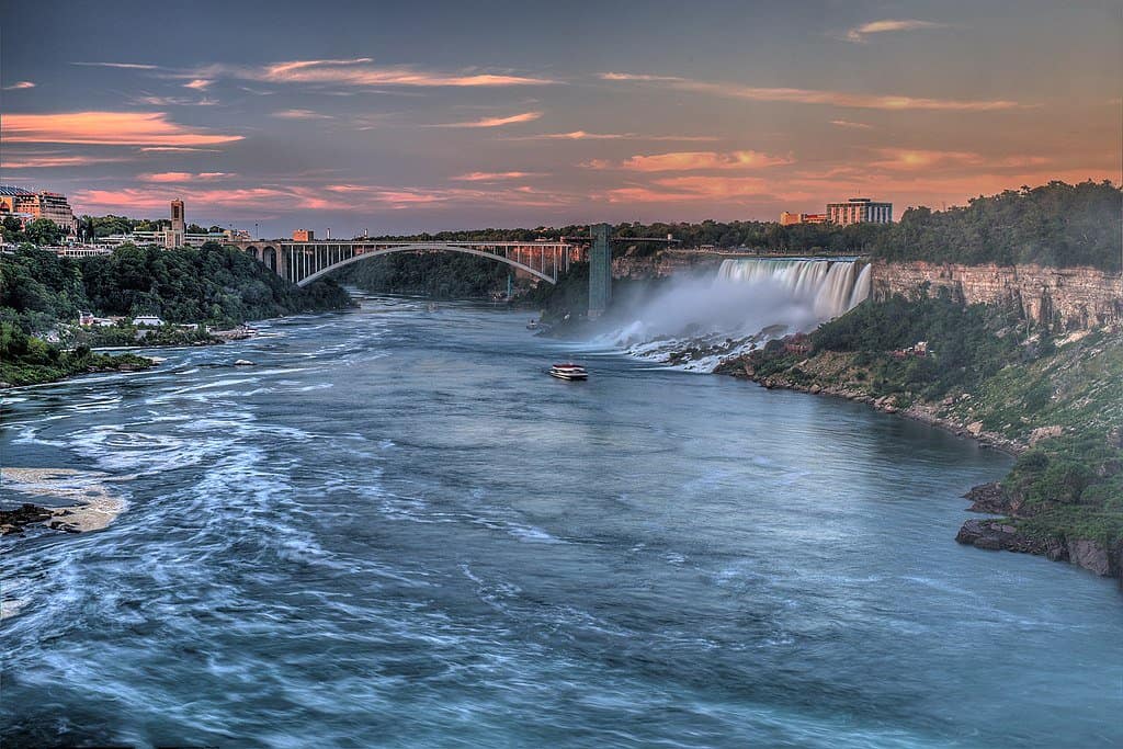 American Falls cascades beside Rainbow Bridge in Niagara, New York.