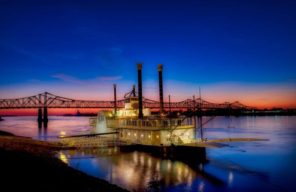 A steamboat sits in front of the Crescent City Bridge. The Crescent City Bridge is one of the highest bridges in the US.
