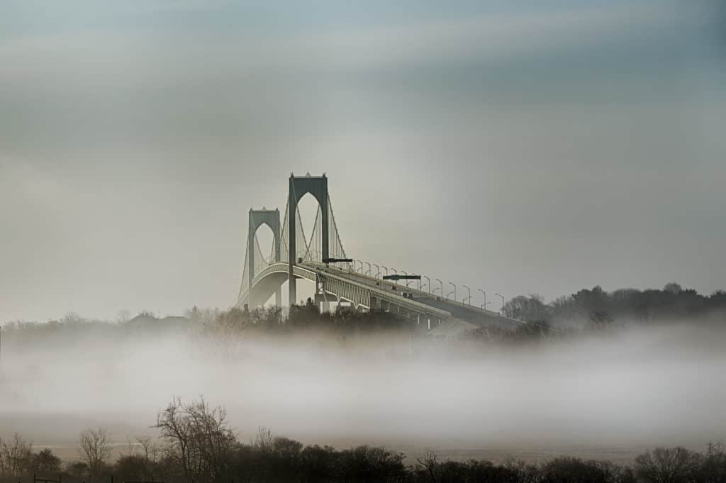 The Claiborne Pell Newport Bridge rises far above the fog. Claiborne Pell Newport Bridge is one of the highest bridges in the US.