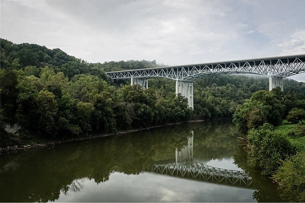 Clays Ferry Bridge is reflected in the calm waters of the Kentucky River. The Clays Ferry Bridge is one of the highest bridges in the US.