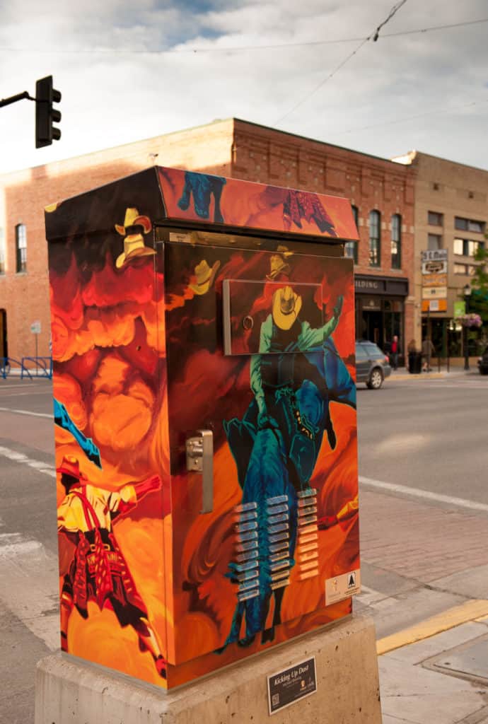 A utility box is colorfully painted with rodeo scenes in downtown Bozeman. Gallatin Art Crossing & Sculpture Park is one of the 21 best museums in Bozeman.