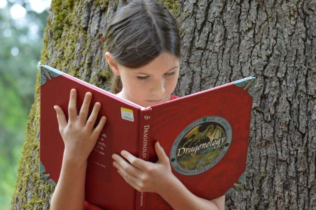 Girl reading a book. Science fiction books for 5th graders.