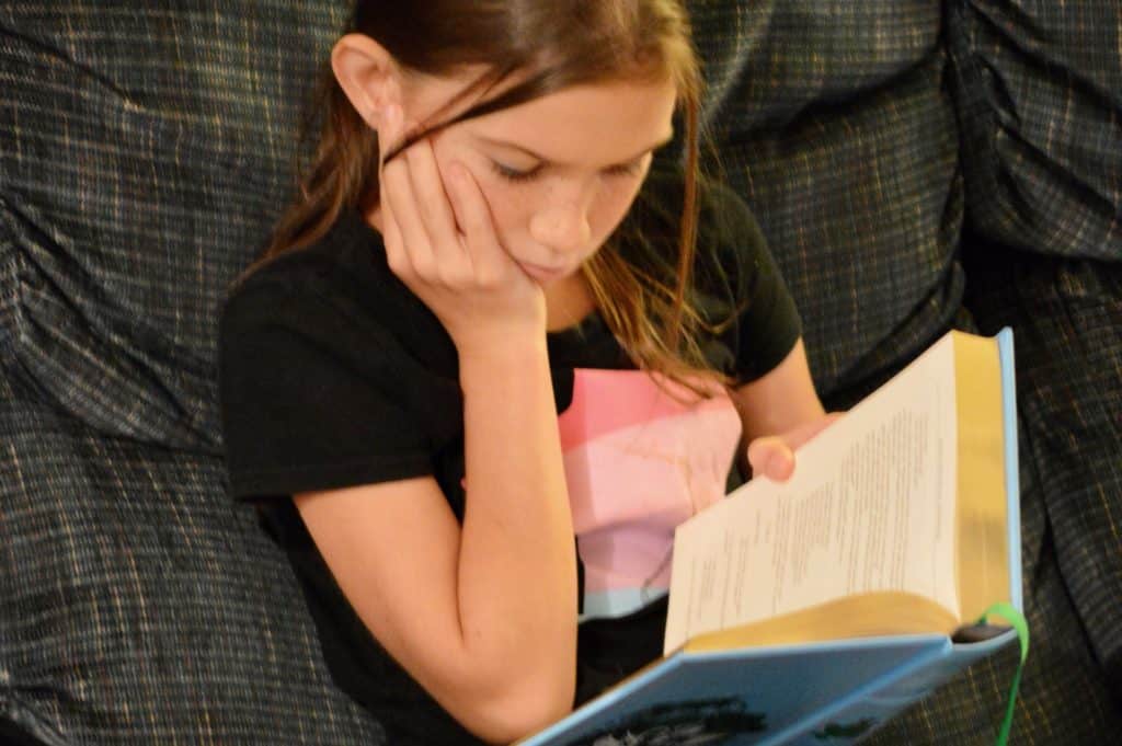 Girl reading a book. Science fiction books for 5th graders.