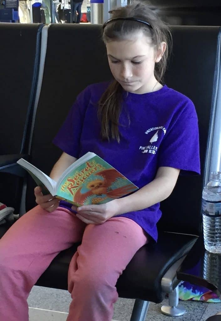 Girl reading a book. Science fiction books for 5th graders.