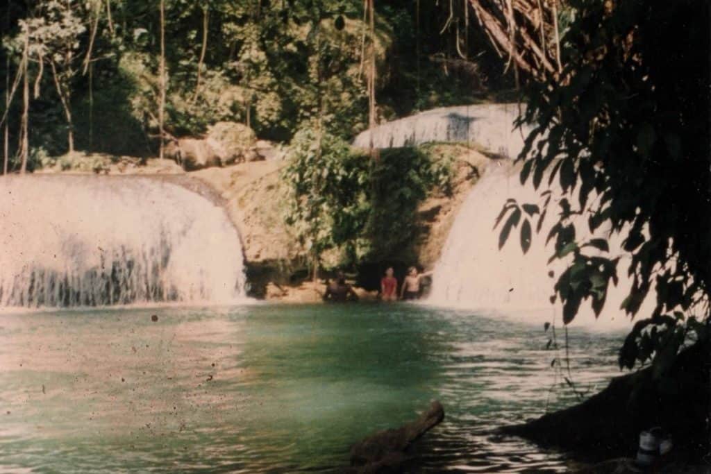 Kids and guide under stone overhang at Y. S. Falls, Jamaica. Reasons why sexual assault survivors don't report abuse.