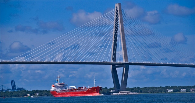 The Arthur Ravenel Jr. Bridge towers over an enormous tanker ship. The Arthur Ravenel Jr. Bridge.