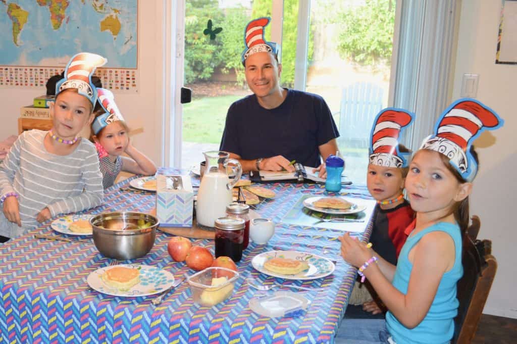 Family at breakfast with Dr. Seuss hats on.