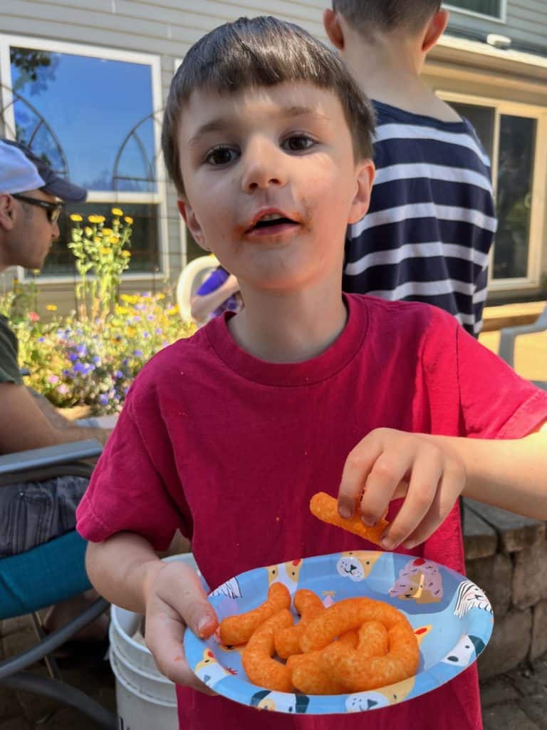 Boy eating Cheetos outside. Repairing a Parenting mistake with teens.