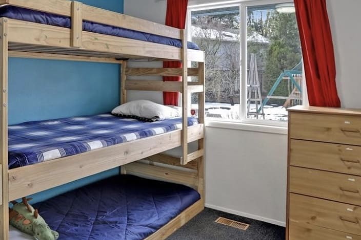 Boys bedroom with triple bunk bed.