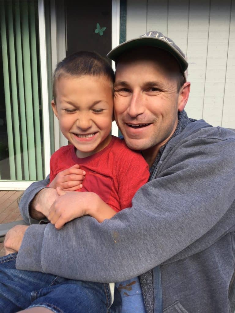 Dad and son smiling. Repairing a Parenting mistake with teens.