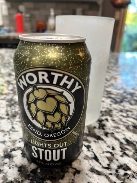 Image shows a can of Worthy Brewing's Lights Out Stout beside a chilled glass.