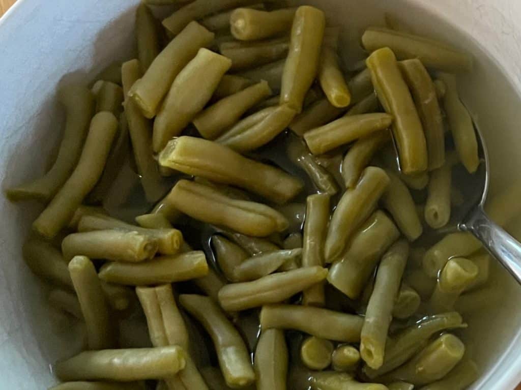 Canned Green beans in a bowl. best canned foods for camping