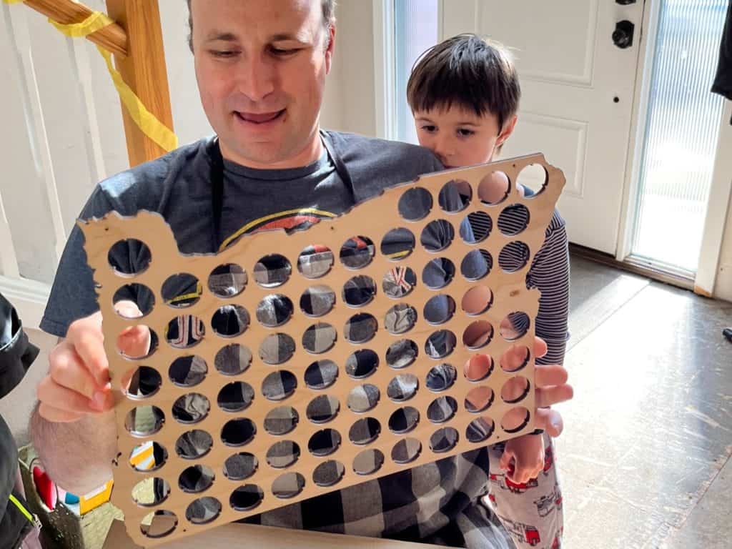 Brian holds his birthday gift of a wooden Oregon State beer cap collector.