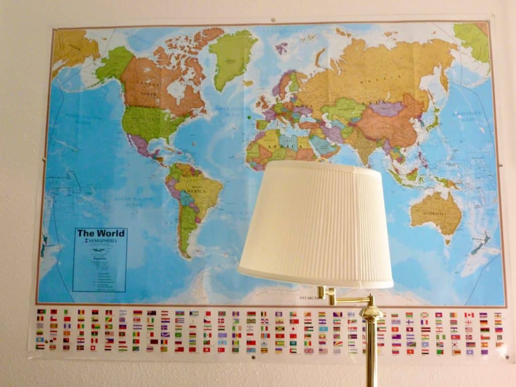 World map with lamp in front.