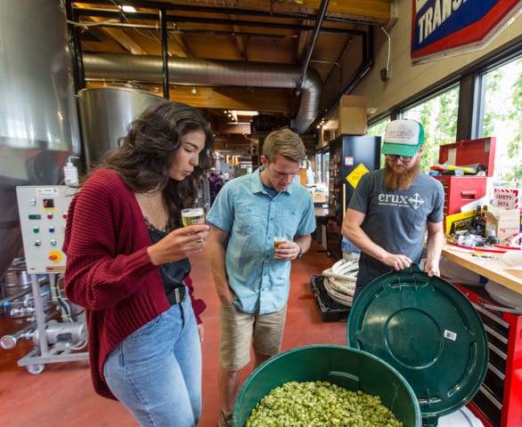 A young couple enjoys a brewery tour at Crux Brewing near Redmond Oregon.
