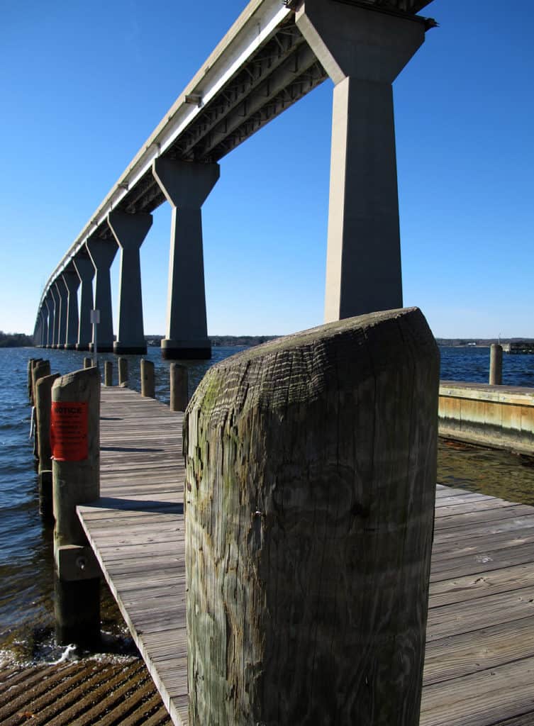 The Governor Thomas Johnson Bridge dwarfs a nearby pier. The Governor Thomas Johnson Bridge is one of the highest bridges in the US.