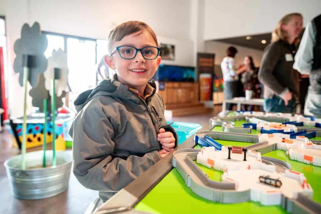 a boy smiles at the Montana Science Center. The Montana Science Center is one of the 21 best museums in Bozeman.