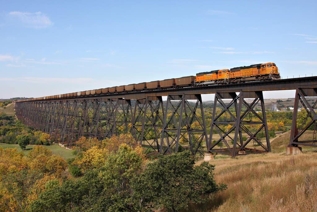 A long train makes its way across Hi-Line Bridge.