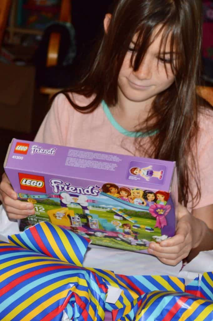 Girl holding Lego Friends box set. Lego gift ideas.