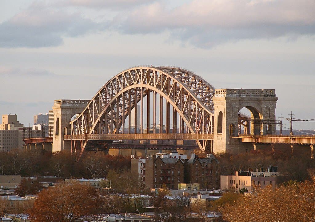 Morning sunlight gilds the historic Hell Gate Bridge. The Hell Gate Bridge is one of the highest bridges in the US.