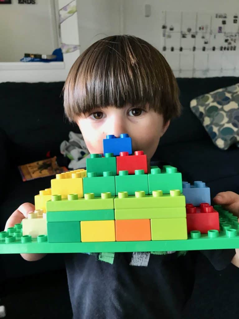 Boy showing his duple creation. 