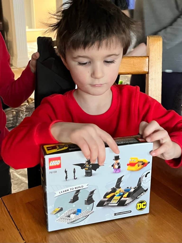 Boy with Lego Batman build set. Lego gift ideas.