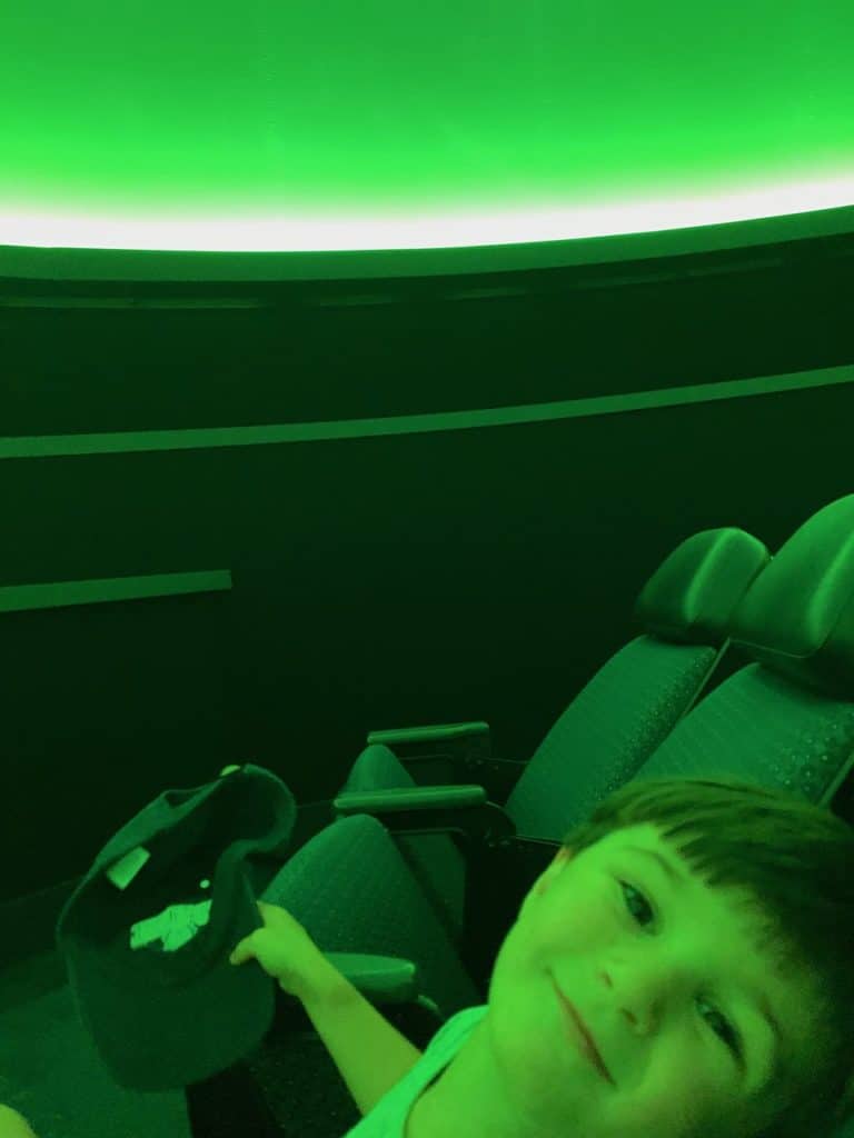 Our young son smiles in the Taylor Planetarium at the Museum of the Rockies.