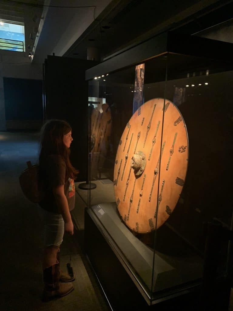 Our daughter studies a viking shield at the special exhibit gallery of the Museum of the Rockies.