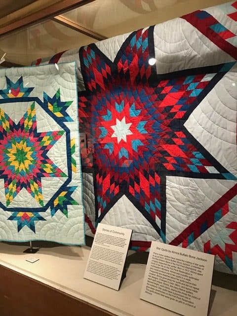 Star quilts hang at a history exhibit at the Museum of the Rockies. 