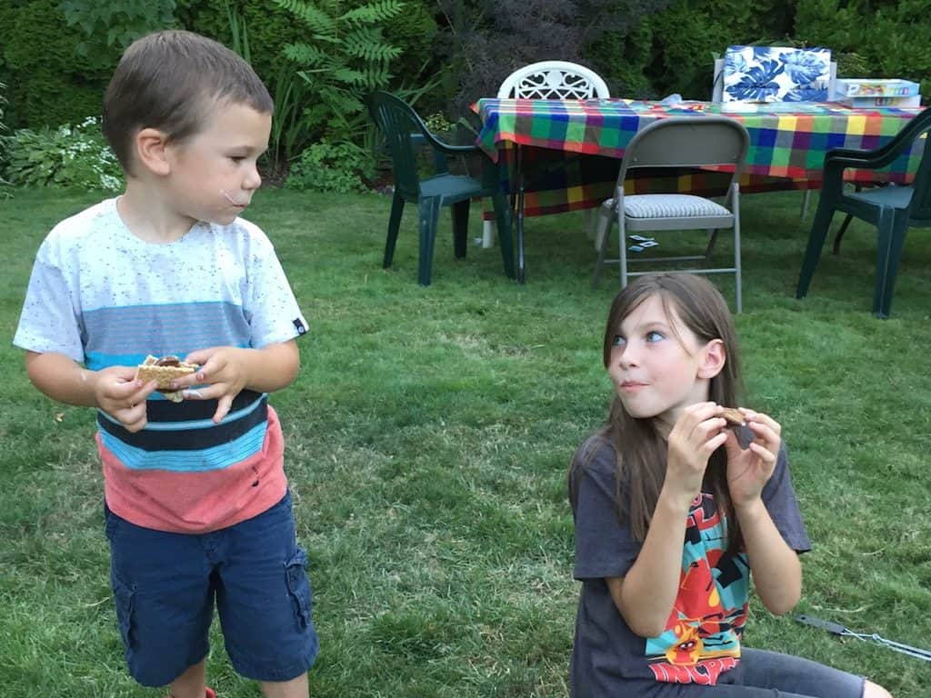 Boy and girl eating s'mores.