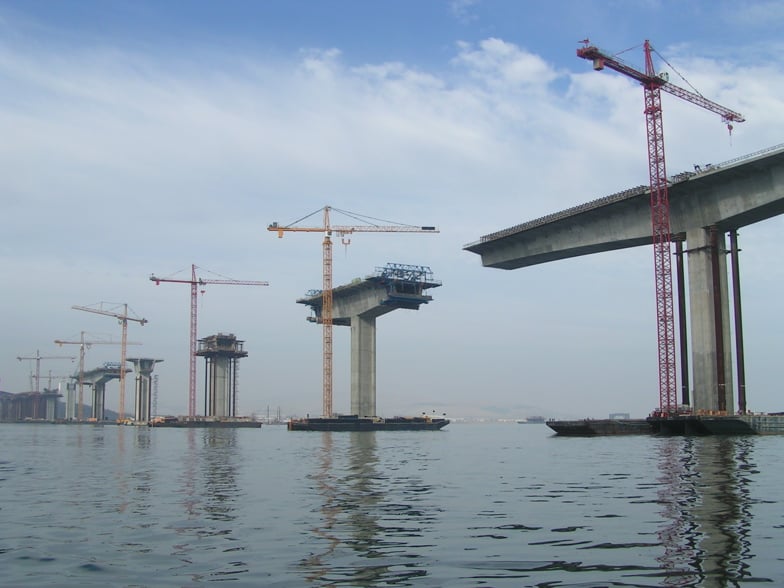 Tall cranes build the titanic concrete pillars that make up the Bernicia-Martinez Bridge.