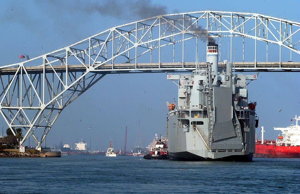 An large naval ship prepares to cruise beneath the Corpus Christi Bridge. The Corpus Christi Bridge is one of the highest bridges in the US.