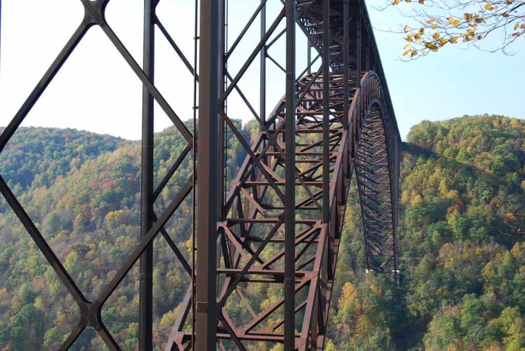 The awesome grandeur of New River Gorge Bridge can be seen in its incredible arch, soaring high above the surrounding forestland.