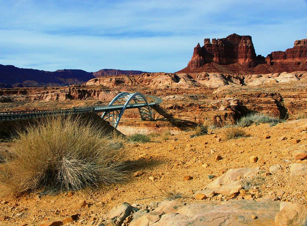 The Hite Crossing Bridge offers passage into a desert wonderland. The Hite Crossing Bridge is one of the highest bridges in the US.