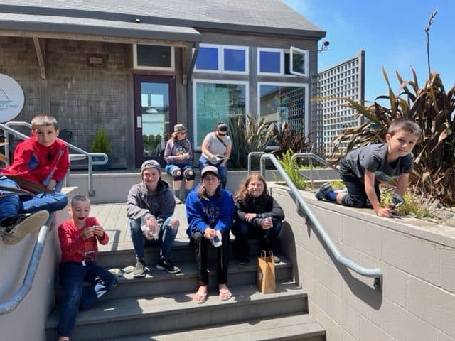 Our family smiles while enjoy a treat from the local candy store in Pacific City. Pacific City is one of the best things to do on the Oregon Coast with kids.