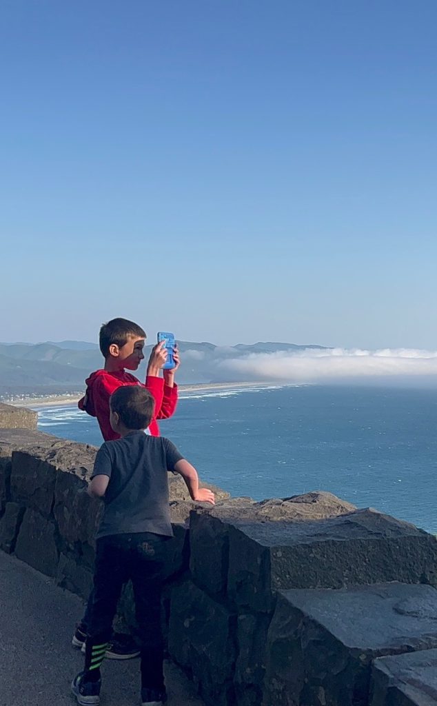 Our sons enjoy the sky-high view at the Neahkanie Viewpoints. The Neahkanie viewpoints are one of the best things to do on the Oregon Coast with kids.